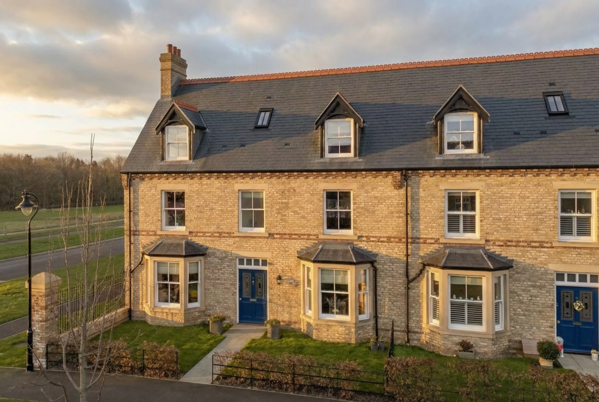 Hero shot of a detached stone residence at Lambton Park showcasing material honesty and atmospheric depth.