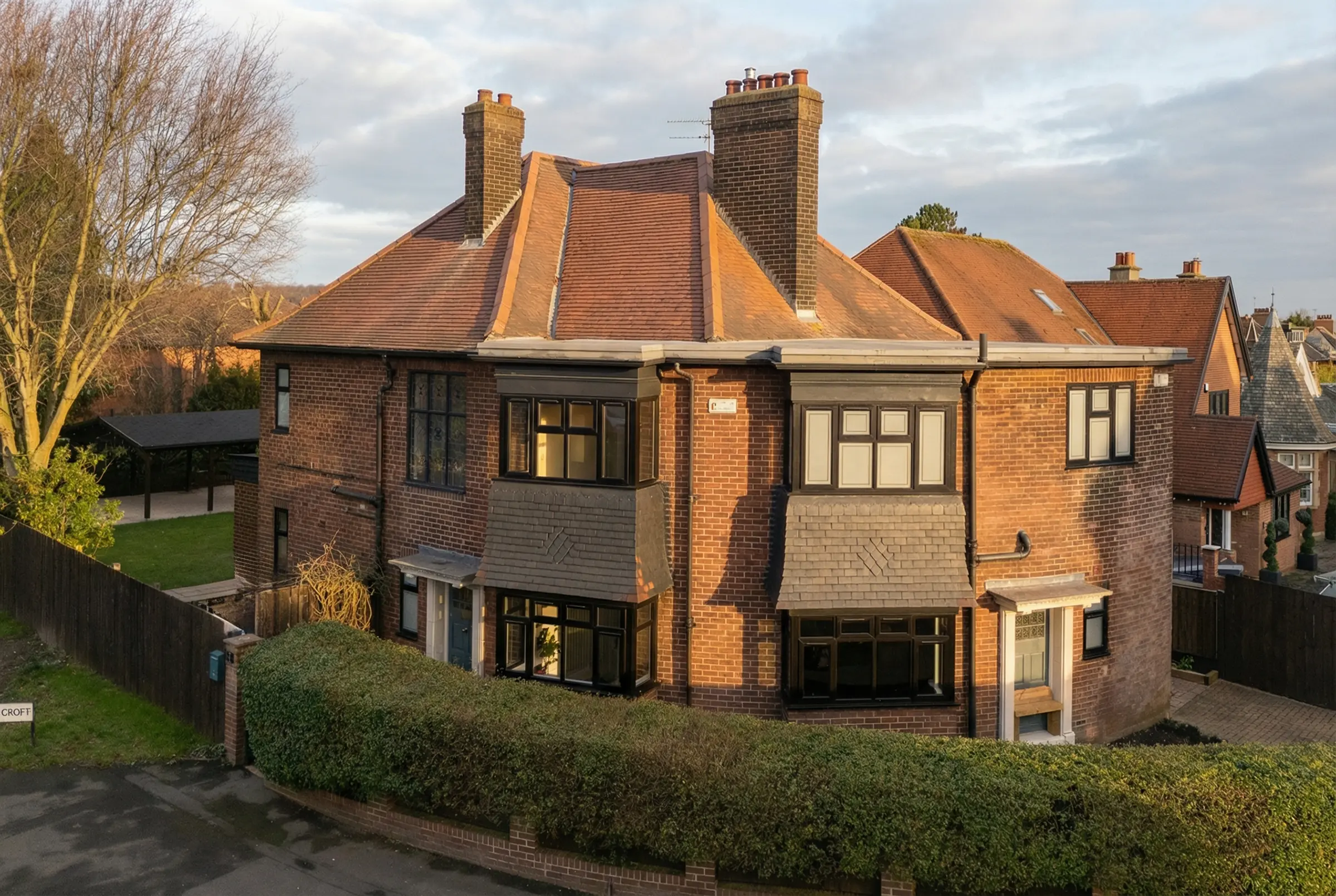 Modern residential architecture featuring a navy door handshake detail and sharp sunset contrast.